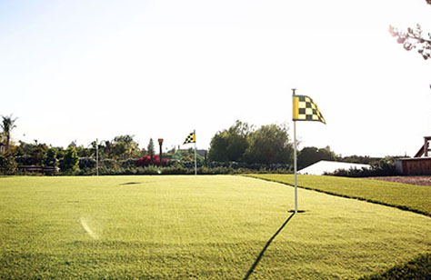 a golf course with flags on the pole