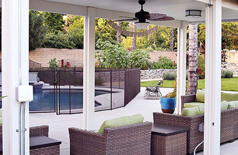 a patio with a pool and chairs